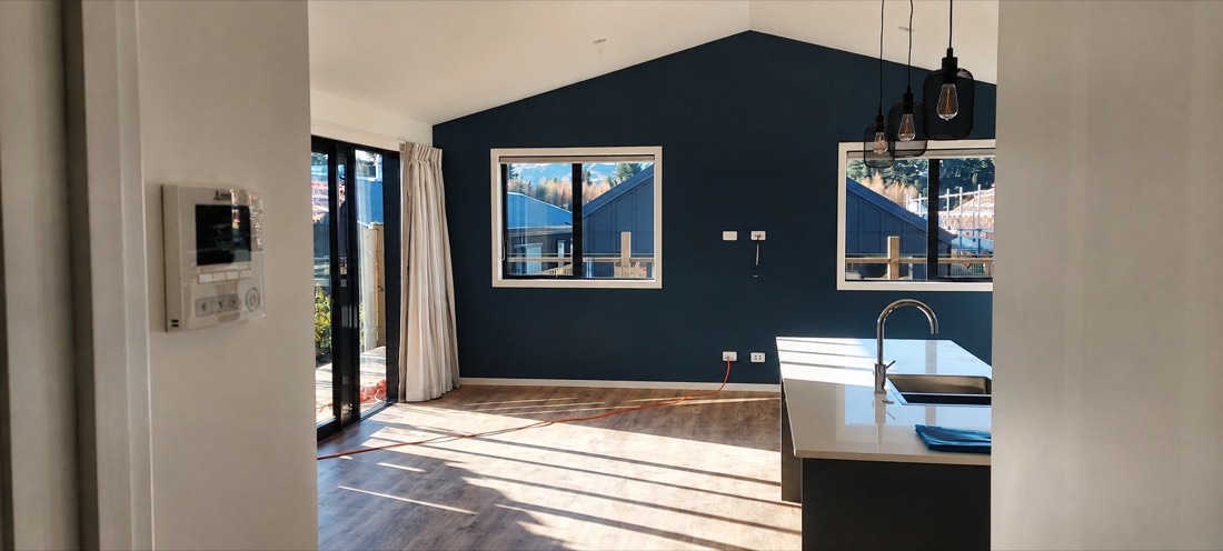 Deep navy feature wall painted in an open plan living room